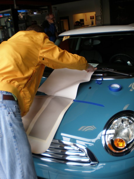 Oxygen Blue MINI Cooper getting all striped up to go home while sitting in